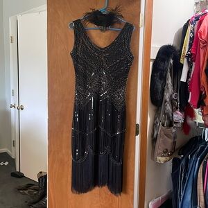 Sexy beaded black dress with feathered headband.